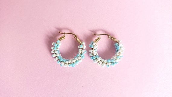 White - turquoise beaded golden colour steel hoops with brass wire.