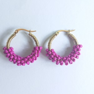 Fuchsia beaded golden colour steel hoops with brass wire.