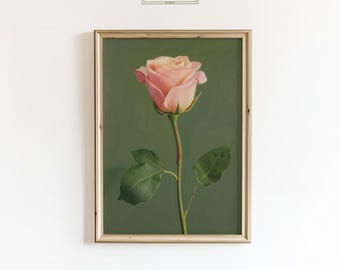 May include: A framed print featuring a pink rose against a green backdrop. The rose is in full bloom, with delicate petals and green leaves. The frame is a light wood color, and the print has the text "ChicGlow" in the top center.