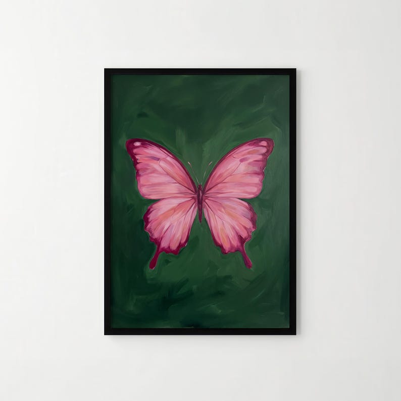 May include: A framed painting of a pink butterfly against a dark green background. The butterfly has detailed wing patterns with varying shades of pink and red. The artwork is enclosed in a black frame, creating a striking contrast.