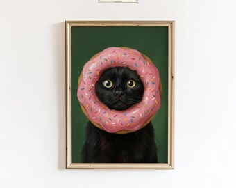 May include: A framed art print featuring a black cat with a pink donut around its head, decorated with colorful sprinkles. The cat has yellow eyes and is set against a dark green background. The print is framed in a light brown wooden frame. The text "ChicGlow" is in the top left corner.
