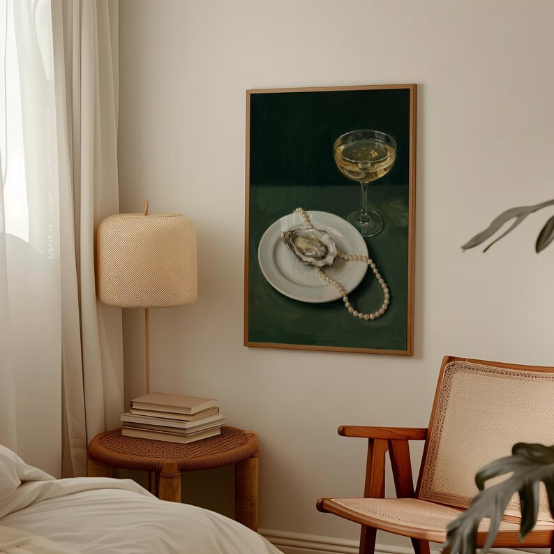 May include: A framed painting depicts a still life with a glass of wine, a white plate with an oyster, and a pearl necklace. The background is a dark green, and the painting is in a wooden frame. The style is reminiscent of classic still life paintings.