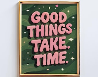 May include: A framed art print with the text "GOOD THINGS TAKE TIME" in pink bubble letters. The background is a dark green with white stars and a few pink hearts. The frame is gold.