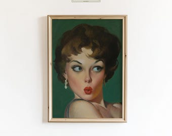 May include: A framed vintage-style print featuring a woman with red lipstick and a surprised expression. The artwork has a green background and is framed in a light-colored wood frame. The print has the text "ChicGlow" in the top center.