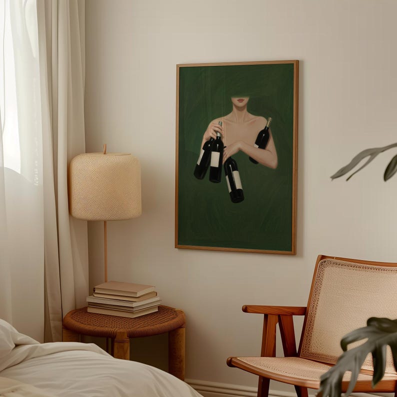 May include: A framed art print featuring a person holding several wine bottles against a dark green background. The artwork has a minimalist style with a focus on the bottles and the figure's arms. The print is in a wooden frame.