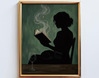 May include: A framed art print depicts a silhouette of a person reading a book, with smoke and stars emanating from the pages. A wine glass sits on a table in front of the person, and a cat rests on their lap. The background is a dark green.