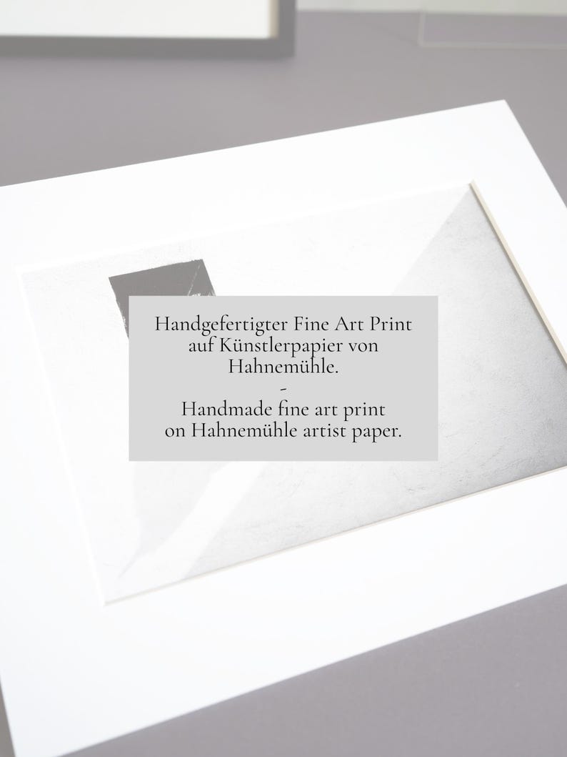 May include: A rectangular fine art print mounted in a white mat board. The print features a black and white abstract composition and includes the text: Handgefertigter Fine Art Print auf K&uuml;nstlerpapier von Hahnem&uuml;hle. Handmade fine art print on Hahnem&uuml;hle artist paper.