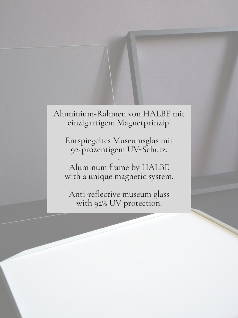 May include: A silver aluminum frame by HALBE featuring a magnetic system and anti-reflective museum glass with 92% UV protection. The text on the frame reads: Aluminum frame by HALBE with a unique magnetic system. Anti-reflective museum glass with 92% UV protection.