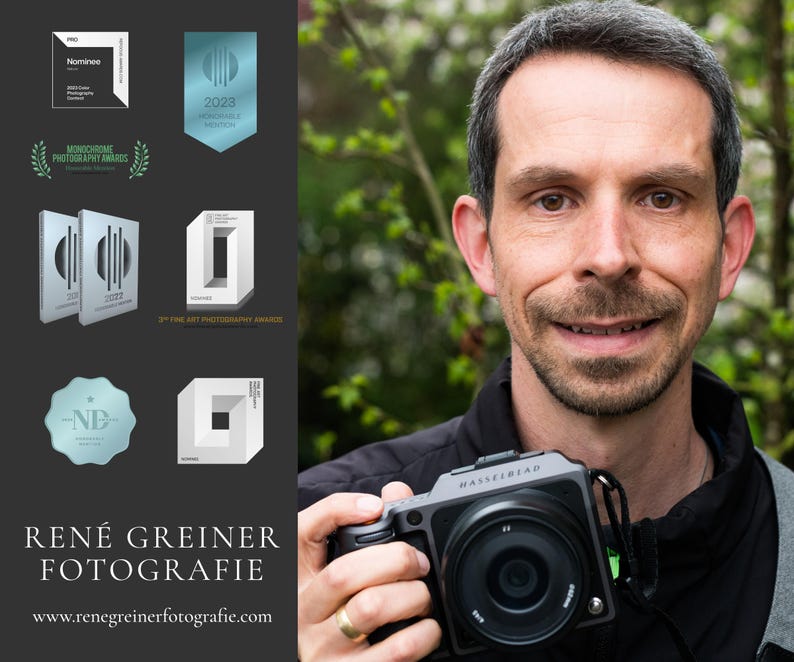 May include: A portrait of a photographer holding a black Hasselblad camera. The left side features a dark gray panel with various photography award logos, the text REN&Eacute; GREINER FOTOGRAFIE, and the website address www.renegreinerfotografie.com.