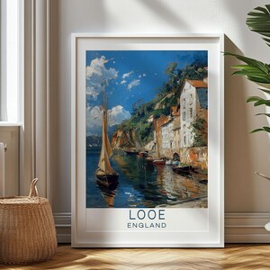 May include: A vintage travel poster featuring a painting of a harbor scene in Looe, England. The poster has a blue background with a white sailboat in the foreground and a picturesque village with colorful buildings on a hillside in the background. The text "Looe, England" is printed in blue at the bottom of the poster.