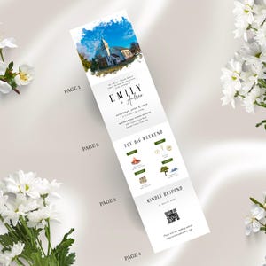 May include: A folded wedding invitation with a watercolor image of a church and blue sky. The invitation includes the names "Emily + Andrea", event details, and a QR code for the wedding website. White flowers are in the background.