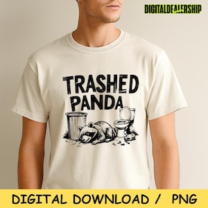 May include: Beige t-shirt featuring the words "Trashed Panda" above a graphic of a raccoon, a bin, and a toilet. The raccoon is lying down. The words "DIGITAL DOWNLOAD / PNG" are at the bottom.