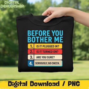 May include: Black sweatshirt with the text "BEFORE YOU BOTHER ME" in blue, with numbered troubleshooting steps in a list. The steps are: "IS IT PLUGGED IN?", "IS IT TURNED ON?", "ARE YOU SURE?", and "SERIOUSLY, GO CHECK."