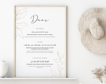 Könnte beinhalten: Ein druckbares Wandbild mit minimalistischem Design. Das Design zeigt eine goldene Umrandung von Blättern und das Wort "Duas" in schwarzer Kalligraphie. Der Text enthält arabische Schrift und englische Übersetzungen für islamische Gebete für Suhoor, Iftar und Laylatul Qadr.