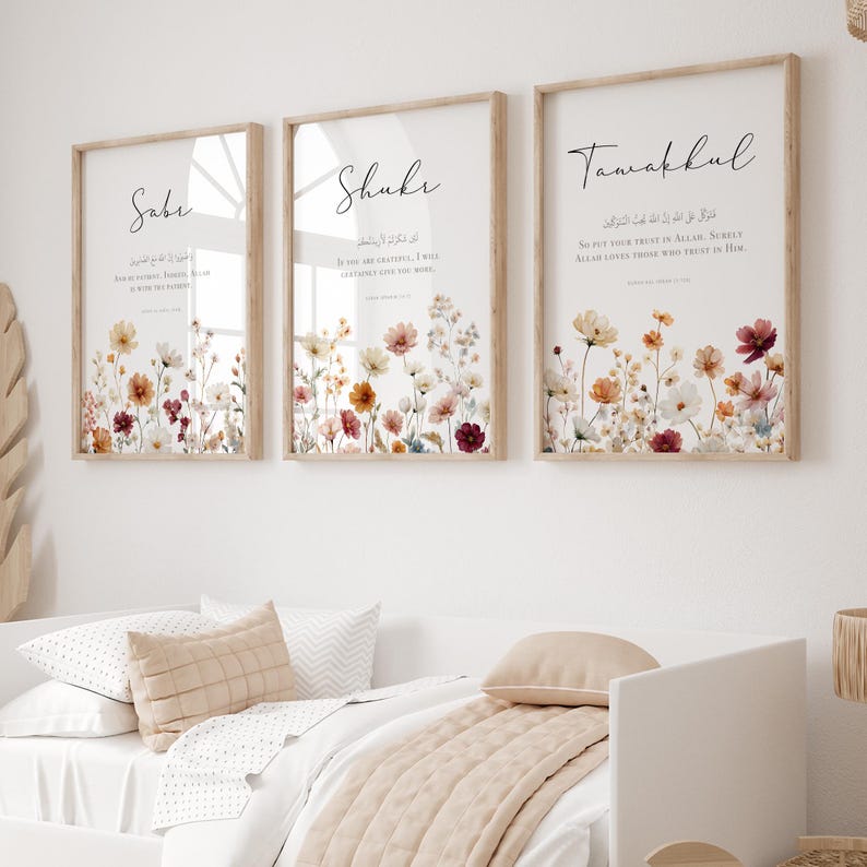 May include: Three framed art prints with floral designs and calligraphy. The prints feature a light wood frame, white background, and colorful flowers in shades of red, orange, and yellow. Each print has a different word in elegant script.