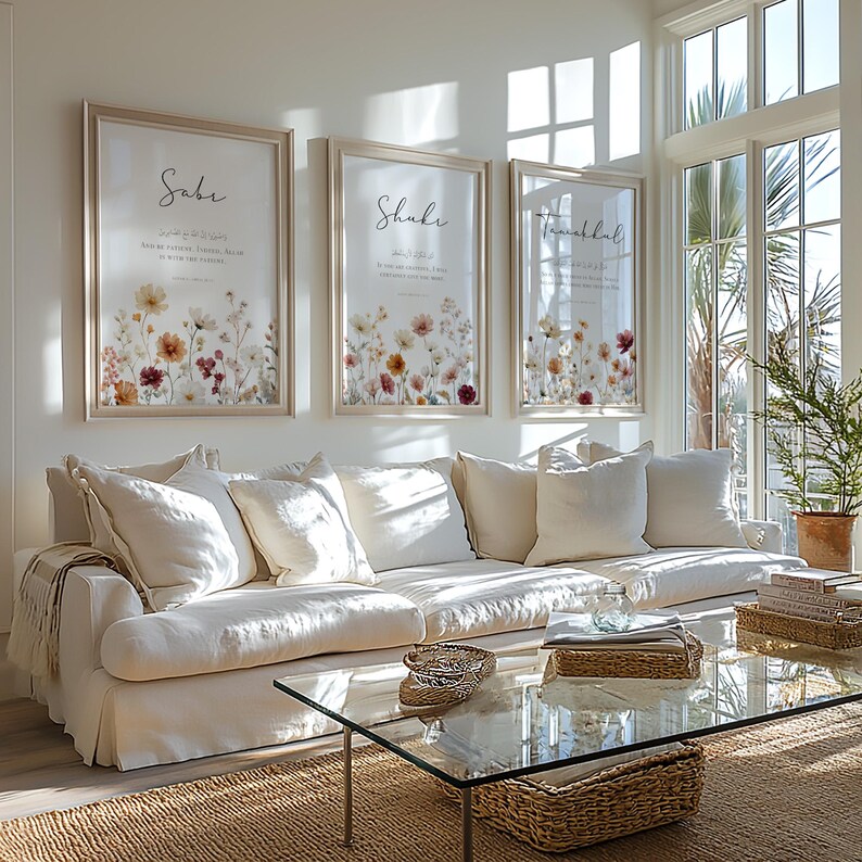 May include: Three framed floral art prints with the words "Sabe", "Shukr", and "Tawakkal" in elegant script. The prints feature a watercolor-style floral design in shades of yellow, orange, and red. The frames are a light wood color.