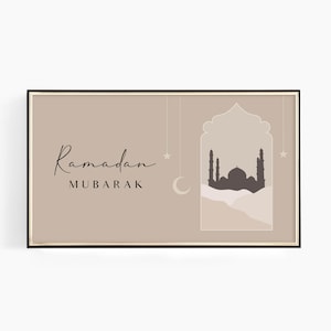 May include: A framed print with a beige background featuring the text "Ramadan Mubarak" and a silhouette of a mosque with stars and a crescent moon.
