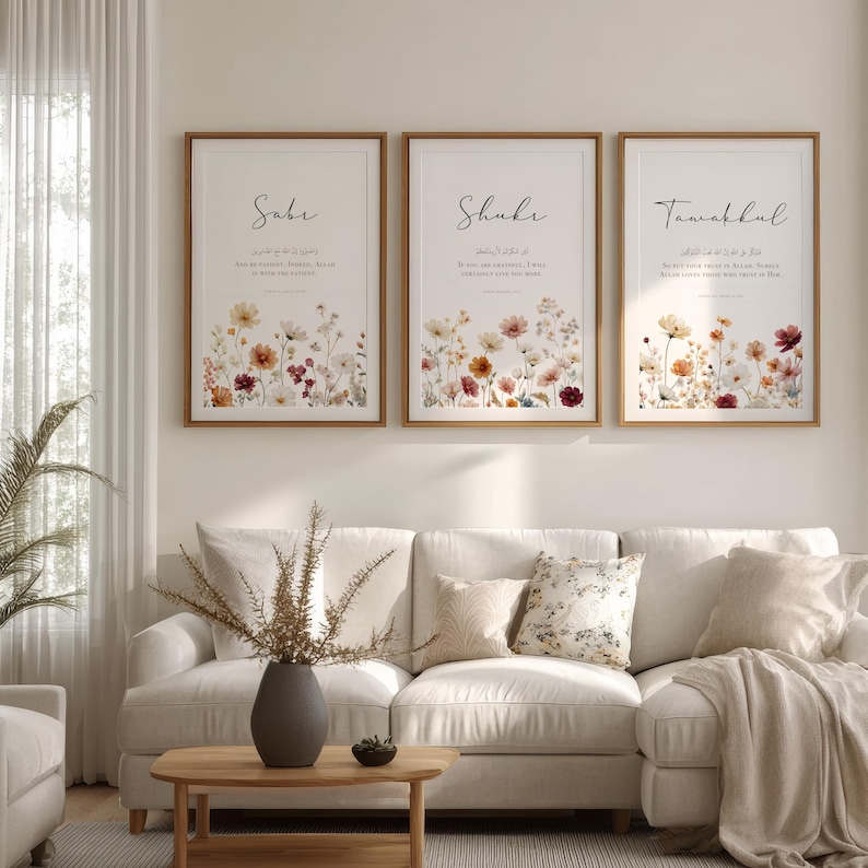 May include: Three framed art prints with floral designs and calligraphy. Each print features a different word: "Sabe", "Shukr", and "Tawakhal". The artwork has a neutral color palette with brown frames, white backgrounds, and colorful flowers.