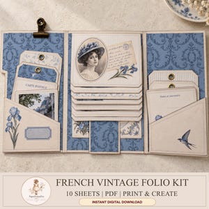May include: A tri-fold paper folio kit featuring blue damask patterns, vintage-style portraits of a woman in a hat, floral iris illustrations, and bird motifs. The kit includes pockets, tags, and cards with text like Carte Postale and Notes et souvenirs.