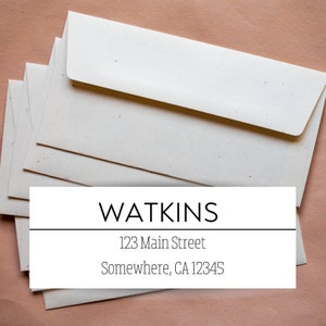 May include: A stack of white envelopes with a return address label that reads "WATKINS, 123 Main Street, Somewhere, CA 12345".