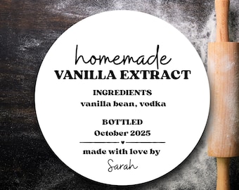 May include: A white circular label with the text "homemade VANILLA EXTRACT" and ingredient details. The label includes "vanilla bean, vodka" and "October 2025". A wooden rolling pin is on the right side of the image.