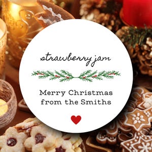May include: A white round gift tag with a red heart, green holly sprigs, and the text "strawberry jam Merry Christmas from the Smiths".
