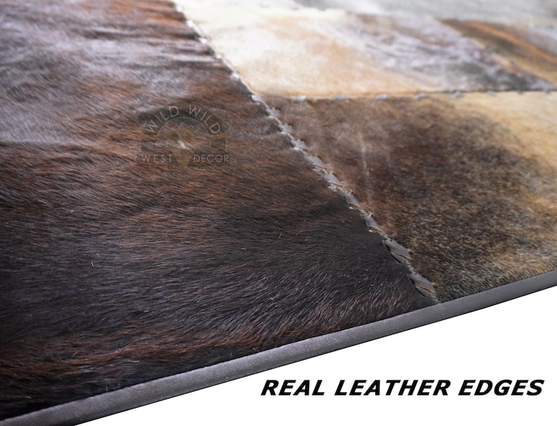 A patchwork cowhide rug with brown, black, and white patches.