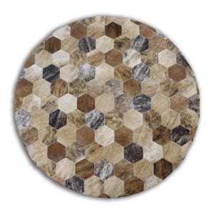 May include: Circular rug featuring a geometric design of brown, tan, and grey hexagonal tiles. The rug has a natural, textured appearance, with variations in colour and pattern. The rug is round and appears to be made of a hide material.