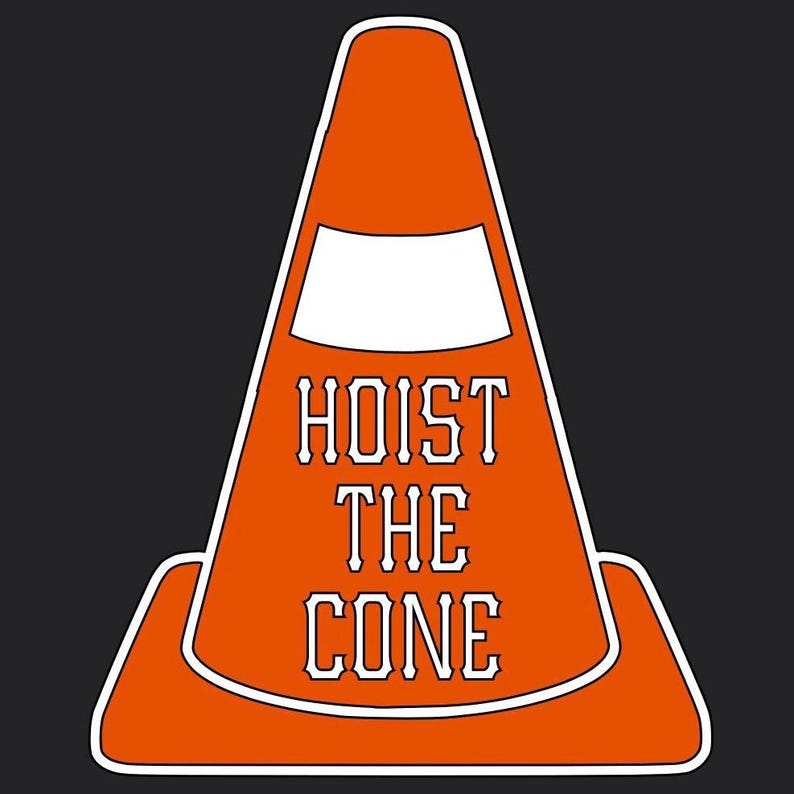 May include: Orange traffic cone graphic with the words "HOIST THE CONE" in white, outlined in orange. The cone is set against a dark gray background. The design is simple and bold.