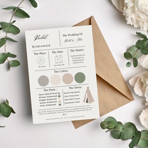 May include: A wedding invitation card with a beige background, featuring text and graphics. The card includes details about the wedding party, date, colors, and dress code. The card is surrounded by white flowers and green foliage.