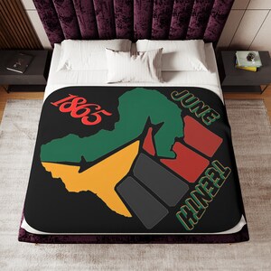May include: Black and white illustration of a raised fist with a green, yellow, and red outline. The fist is in the shape of Africa. The text "Juneteenth 1865" is written in red on the image.