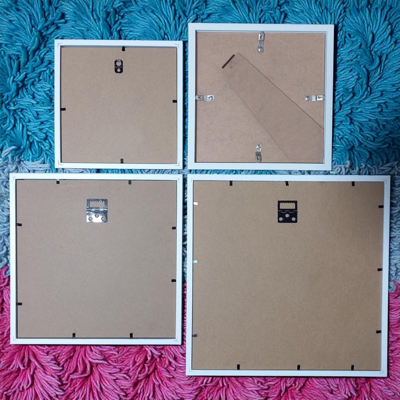 Rear view of four frame sizes showing their backing boards, hanging fittings and stands.