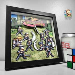 May include: A framed 3D paper art piece featuring a scene from "Dragon Force." The artwork depicts pixelated characters in a battle scene with swords and shields. The frame is black, and the background shows a castle and green landscape.