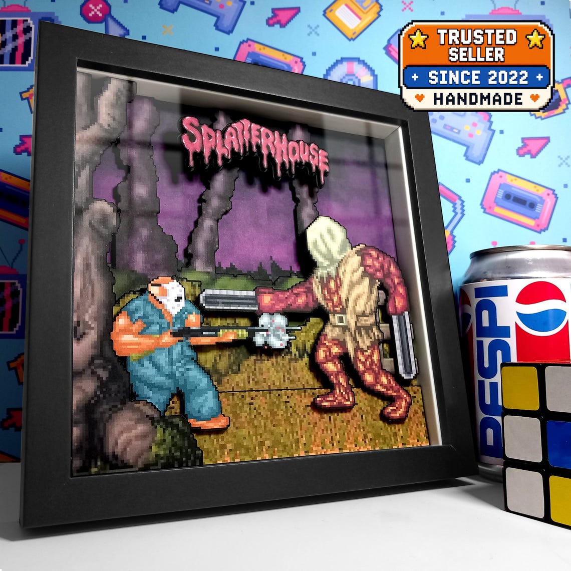 Black-framed Splatterhouse Biggy Man pixel art shadow box showing Rick Taylor facing the chainsaw-armed boss