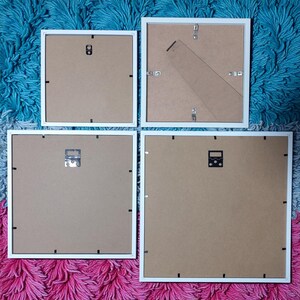 Rear view of four frame sizes showing their backing boards, hanging fittings and stands.