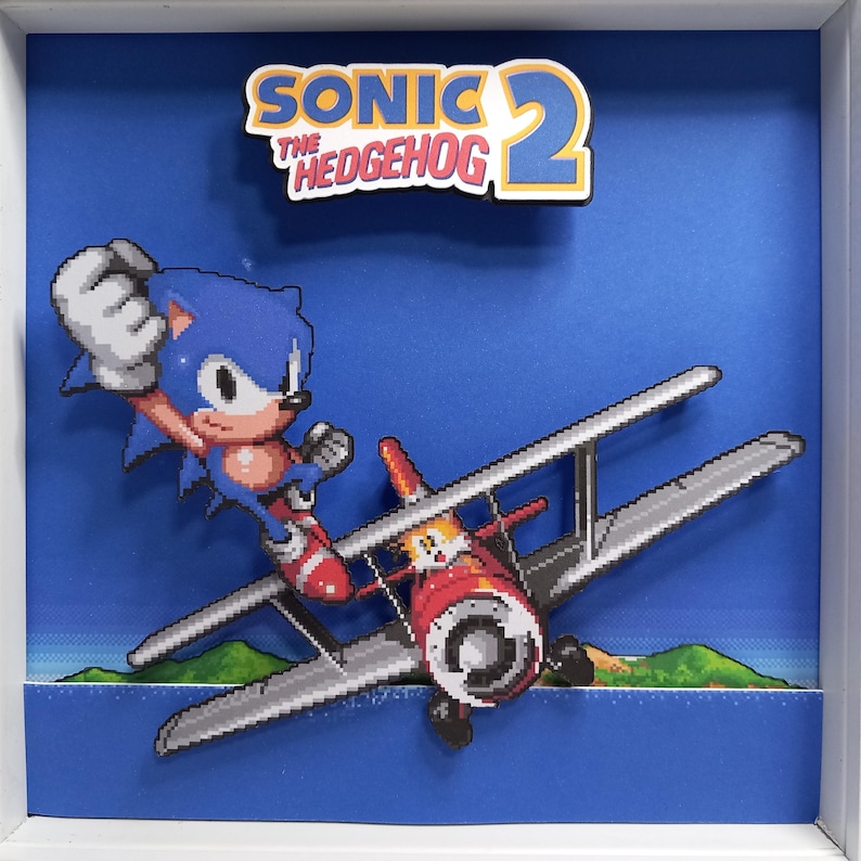 Front view of the Sonic the Hedgehog 2 shadow box with Sonic beside the biplane.