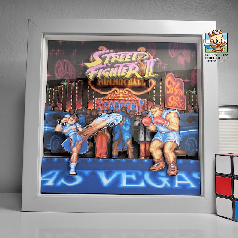 Front view of the framed Street Fighter II shadow box showing Chun-Li versus Balrog on the Las Vegas stage.