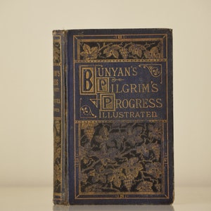 May include: A vintage, blue book with gold lettering and illustrations. The title is "Bunyan's Pilgrim's Progress Illustrated".