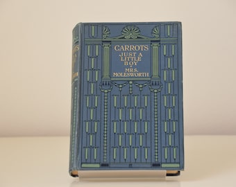 May include: A blue book with a gold title that reads "Carrots Just a Little Boy by Mrs. Molesworth". The cover features a decorative design with green and gold accents.