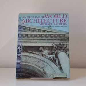 May include: A book titled "An Outline of World Architecture" by Michael Raeburn. The cover features a black and white photograph of a building with an archway and a sculpture.