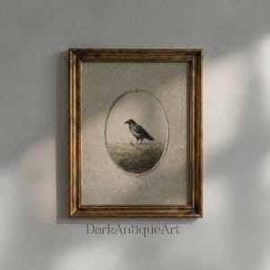 May include: A rectangular dark wood frame containing a print of a black bird standing on a grassy patch. The bird is centered within an oval border on a textured beige background. The text DarkAntiqueArt is printed in black at the bottom center.