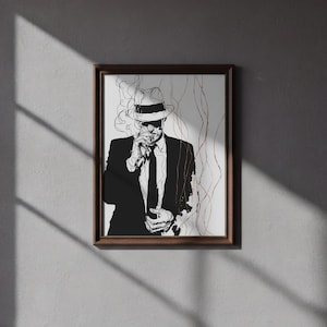 May include: A framed black and white art print of a person in a suit and fedora smoking. The artwork features a minimalist line drawing style with wisps of smoke and a dark brown frame.