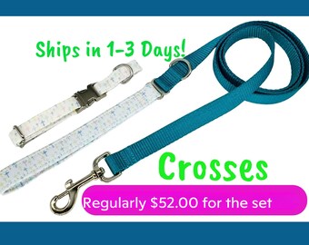 May include: A white and blue dog collar and lead set with a cross pattern. The lead is teal blue and has a silver hook. The collar has a silver buckle. The text "Ships in 1-3 Days!" and "Crosses" is visible in the image. The text "Regularly £52.00 for the set" is also visible in the image.