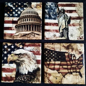 May include: Set of four square tiles featuring patriotic American imagery. Designs include the U.S. Capitol building, the Statue of Liberty, a bald eagle, and a map of the United States, all set against a backdrop of the American flag.