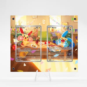 May include: Two Pokemon trading cards, Plusle and Minun, are displayed in protective cases. The Plusle card features a yellow creature with red ears, while the Minun card shows a blue creature. The background depicts a party scene with food and decorations.