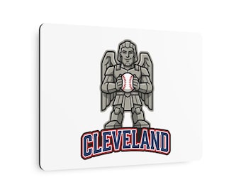 May include: A rectangular white mouse pad featuring a graphic of a grey stone-like guardian figure with wings holding a baseball. Below the figure, the word CLEVELAND is printed in bold blue letters with a red outline on a white background.