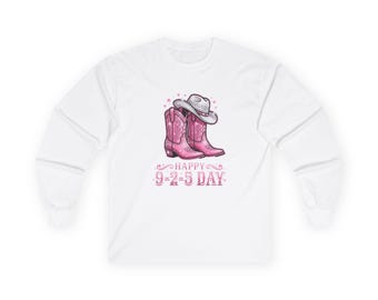 May include: A white long-sleeve shirt featuring a graphic of a pair of pink cowboy boots and a white cowboy hat. Below the boots, the text reads HAPPY 9-2-5 DAY in pink lettering, surrounded by small decorative stars and flourishes.