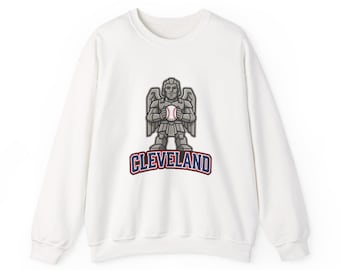 May include: A white long-sleeve sweatshirt featuring a graphic of a gray stone-like winged figure holding a baseball. Below the figure, the word CLEVELAND is printed in bold blue letters with a red outline, centered on the chest of the garment.