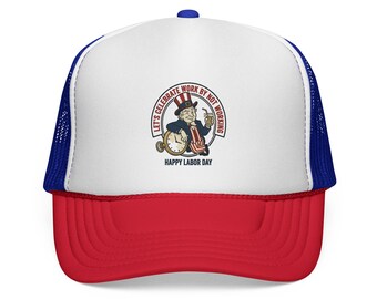 May include: A white, red, and blue trucker hat featuring a graphic of Uncle Sam holding a drink and leaning on a clock. The text reads: LET'S CELEBRATE WORK BY NOT WORKING and HAPPY LABOR DAY. The hat has a white front panel, red brim, and blue mesh back.
