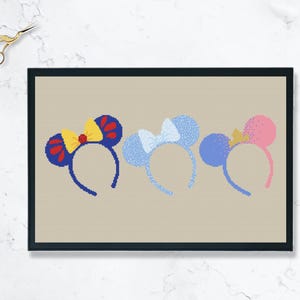 May include: Three pairs of blue, pink, and white mouse ears with bows. The ears are on a beige background.